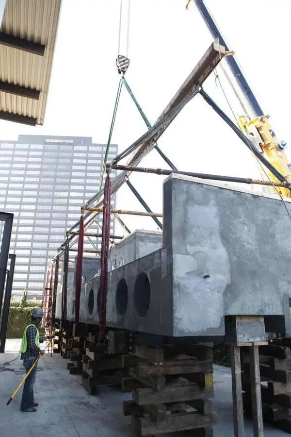 A precast structural beam suspended from a crane rig, showing the scale Zenith's structural work runs to.